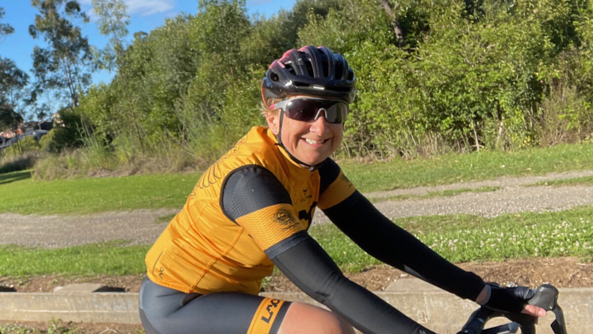 Smiling woman riding a road bike